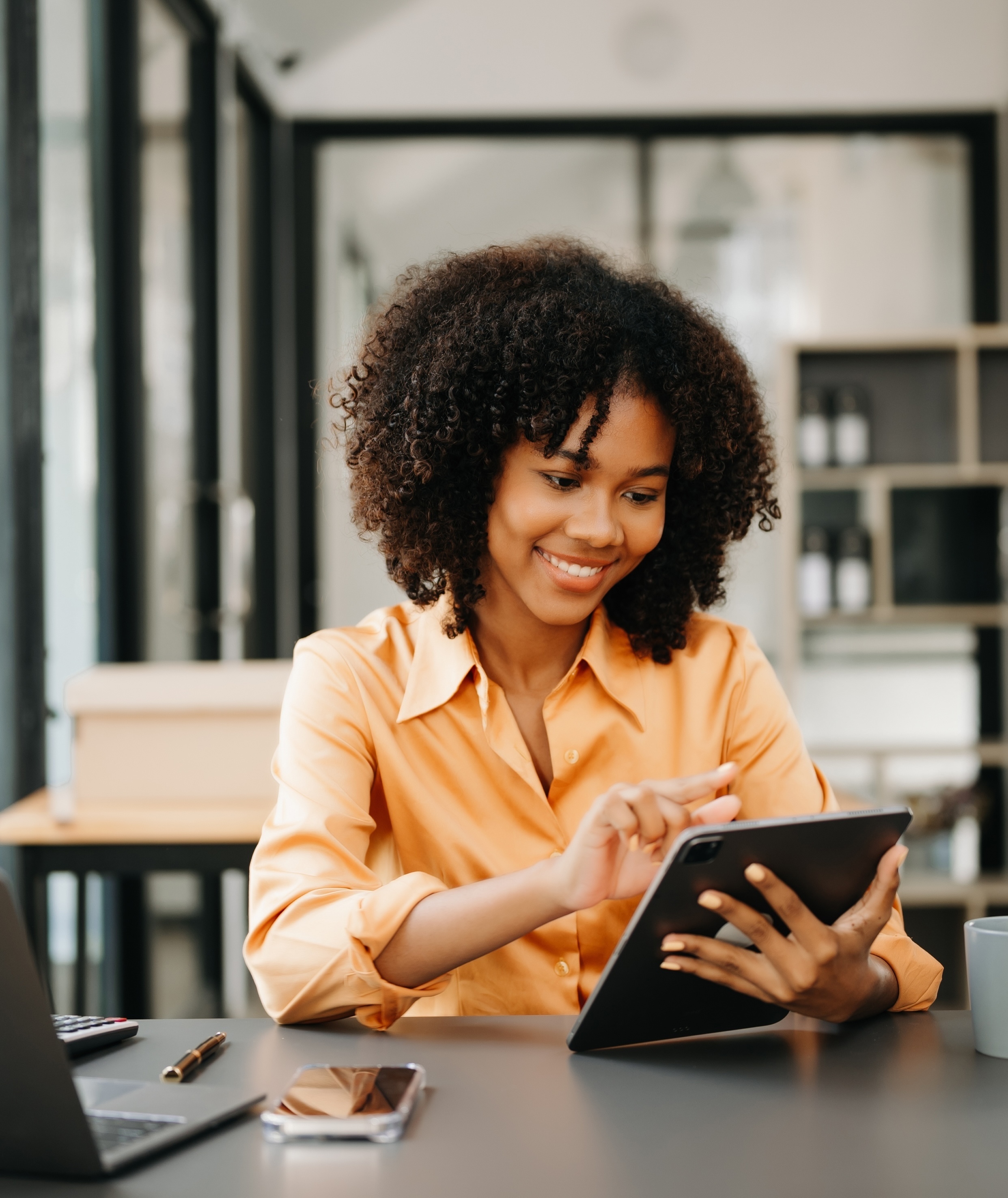 Business woman using tablet and laptop for doing math finance on an office desk, tax, report, accounting, statistics, and analytical research concept in office